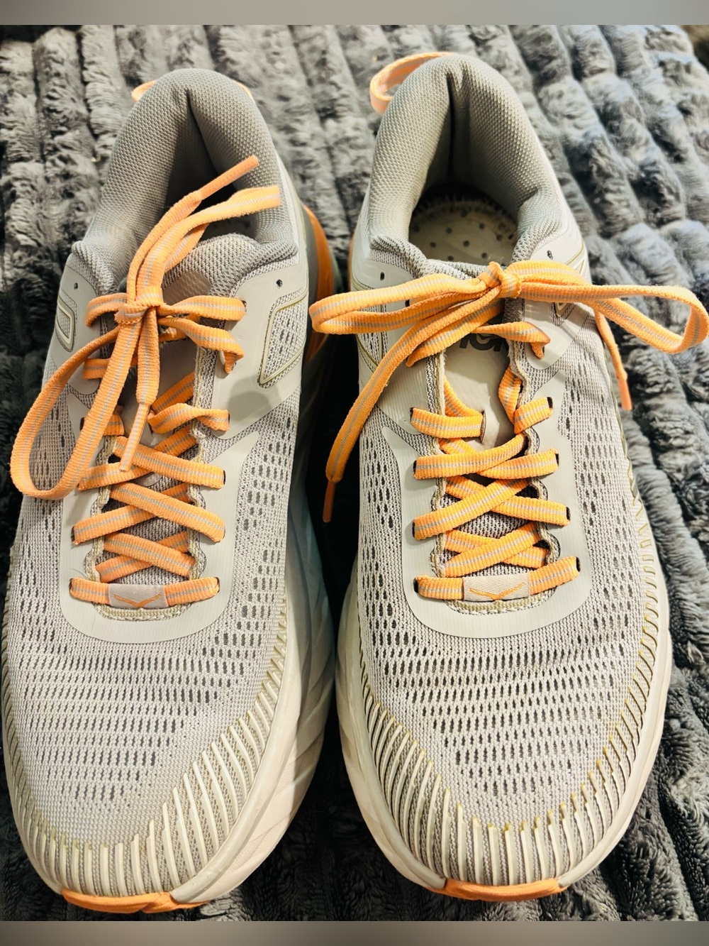 Hoka One One Light Gray Running Shoe with Orange Accents